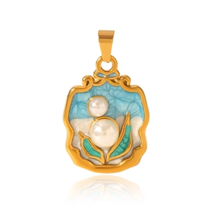 Detail of gold-rimmed blue enamel shell pendant with pearls and green leaves on white background