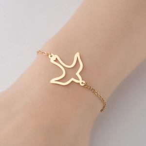 Minimalist 18K gold plated stainless steel bracelet featuring a hollow bird pendant