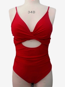 Detail of red one-piece swimsuit featuring chic front knot design and cutout detail
