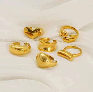 Detail view of six piece gold titanium steel rings set with heart and irregular designs