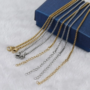 Detailed view of gold and silver stainless steel necklaces with lobster clasps and extenders