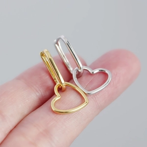 Minimalist S925 silver heart dangle earrings in gold and silver finish shown on finger
