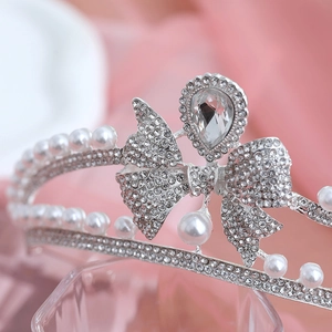 Detailed macro of vintage silver bridal crown with crystal bow and white pearls