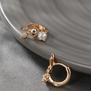 Detail of bunny drop earrings with rose gold metal and large sparkling round zircon