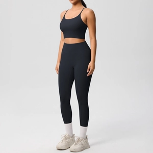 Detail of black high-waist seamless yoga leggings and thin strap sports bra set