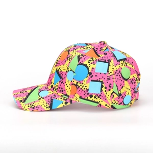 Pink and yellow baseball cap with colorful geometric prints and curved brim on white background