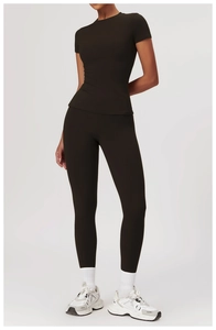 Detail of dark brown tight yoga set showing soft brushed fabric and high-waist fit