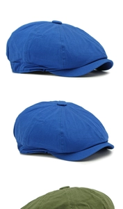 Detail of royal blue and olive green cotton newsboy caps with eight-panel stitching