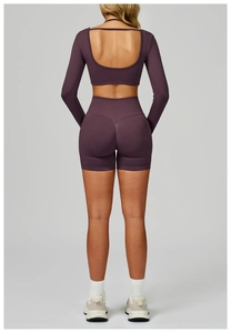 Detail of dark purple seamless two-piece sports set with U-shaped open back and ribbed texture