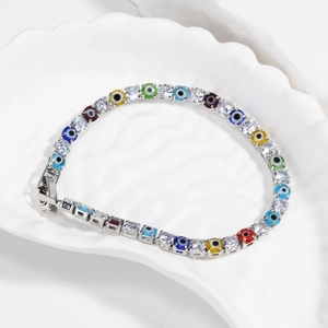 Detail of silver tennis bracelet with colorful evil eye beads and cubic zirconia stones