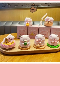 Detailed set of six cute pink Buddha-themed pig resin figurines with lotus bases and box