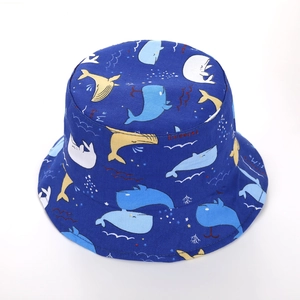 Detailed view of kids sun hat with cartoon whale prints and swimming text patterns