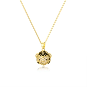 Macro detail of golden monkey pendant necklace with black and white crystal inlay