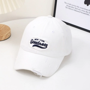 Détail de la casquette de baseball en coton blanc avec broderie et bordure effet usé