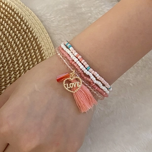 Handmade multilayer beaded bracelet set with pink daisy charms and love heart pendant