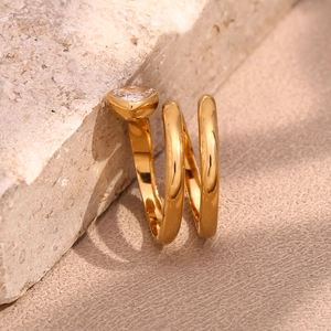 Close-up of triple-layered 18K gold plated ring with heart-shaped white zircon detail