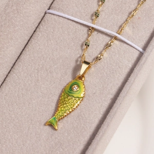 Golden necklace with green and yellow enamel koi fish pendant featuring a small clear gemstone
