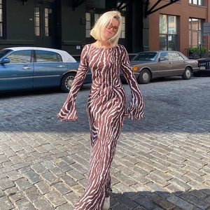 Zebra print bohemian maxi dress with long sleeves in an urban street setting