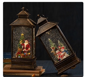 Vintage bronze Christmas lantern with swirling glitter and festive Santa figurines