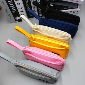 Close-up of multi-colored large capacity square canvas pencil bags with double zippers