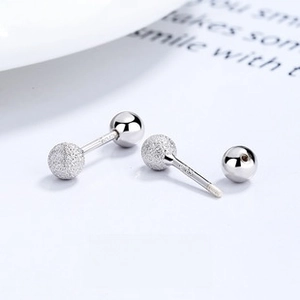 Detailed macro view of S925 sterling silver screw back earrings with matte and mirror finish