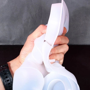 Close-up of flexible translucent silicone mold showing high elasticity and durability