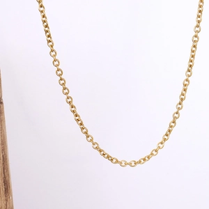 Detailed view of an 18k gold plated stainless steel O-chain necklace on a wooden stand
