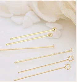 Macro shot of 14K gold plated ball, flat, and eye pins for DIY jewelry making