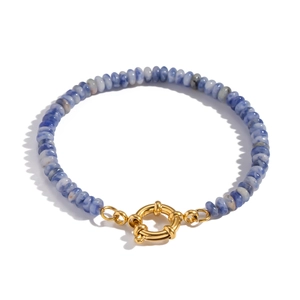 Detail of blue marble beads bracelet with golden spring clasp on white background