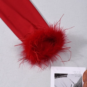 Detail of red long sleeve top featuring fluffy ostrich feather cuffs for a luxury finish