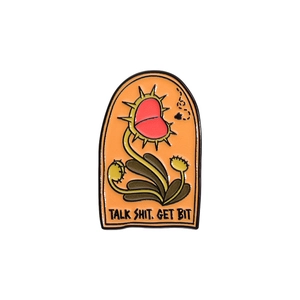 Funny carnivorous plant enamel pin with Talk Shit Get Bit text on orange background