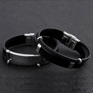 Close-up of black braided leather bracelets with polished stainless steel clasp details