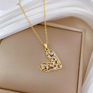 Elegant gold hollow heart pendant necklace with CZ crystals on a silk display