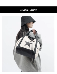 Detail of canvas drawstring tote featuring a bold black star logo and contrast bottom