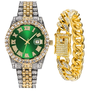 Macro view of gold-tone iced-out watch with green sunray dial and Cuban link bracelet