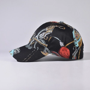 Side view of black baseball cap featuring vintage gold baroque chain and nautical prints