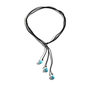 Detail view of Bohemian long cord necklace with three natural turquoise stone beads