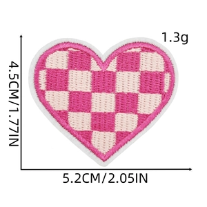 Detail showing pink and white checkered heart embroidery patch with size measurements