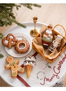 Detail of gingerbread style Christmas ornaments including donut and Santa motifs