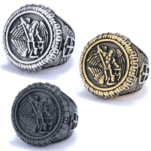 Detailed close-up of Saint Michael Archangel relief rings in silver, gold, and black finish