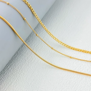 Detail of 18K gold-plated satellite, snake, and curb chains showing exquisite metal texture