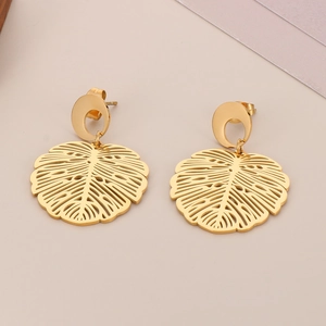 Detailed view of hollowed-out monstera leaf earrings with 18K gold-plated finish