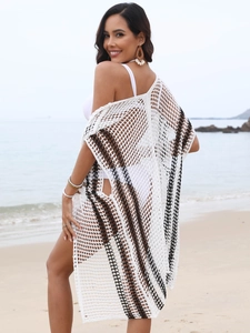 Detail of crochet knit beach cover-up featuring black stripes and hollow mesh pattern