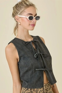 Detailed view of dark charcoal denim vest featuring triple front bow tie fastenings