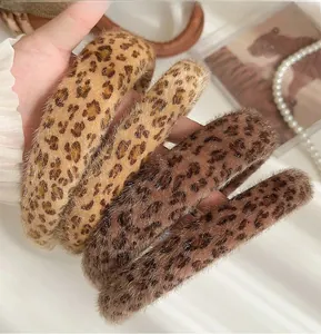 Detail of four fluffy leopard print headbands with soft faux fur texture for winter