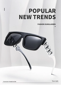 Detail of punk sunglasses with oversized black frame and silver chain temples on a display