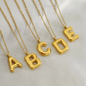 Polished gold balloon initial pendant necklaces A-E in a minimalist puffy bubble style