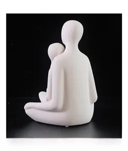 Close-up of matte white ceramic couple figurine showing textured surface and abstract art
