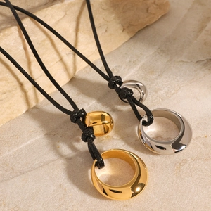 Irregular hollow metal pendant necklace in gold and silver finish with black cord strap