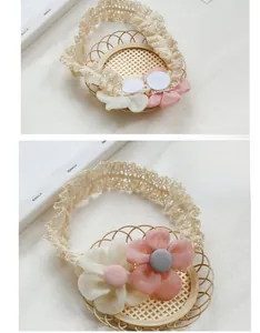 Detail of baby lace headband featuring 3D chiffon flowers in pink and cream beige tones
